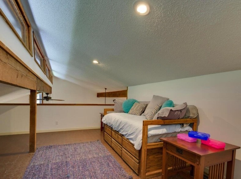 3 Hull Circle Austin, TX 78746 - Photo 27 of 32 a bedroom with furniture and a window