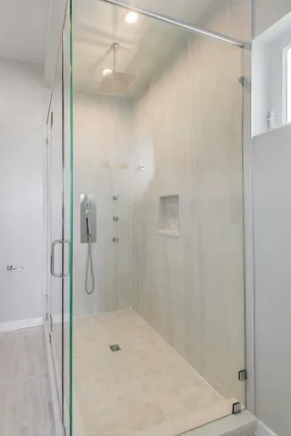 a bathroom with a shower and a sink