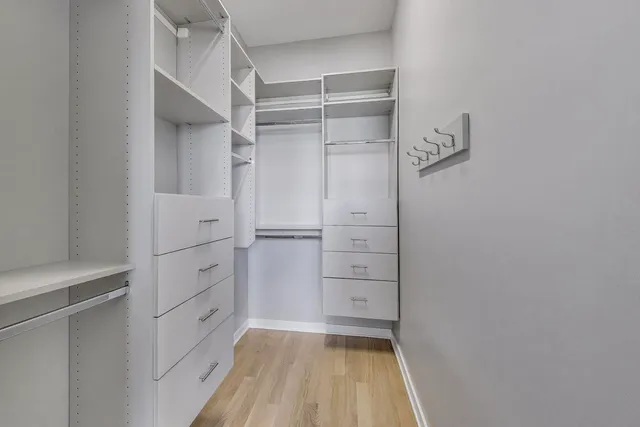 a view of walk in closet with empty racks
