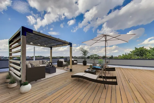 a living room with patio furniture and a wooden floor
