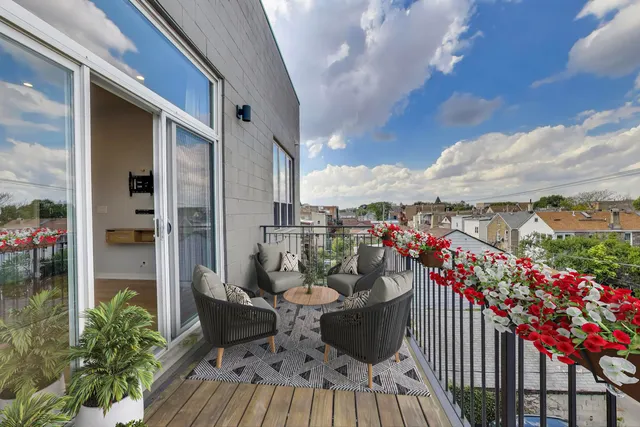 a view of a balcony with furniture