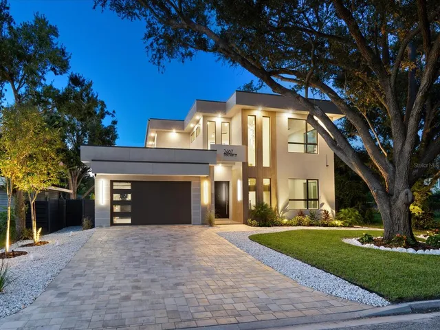 a front view of a house with a yard and a garage