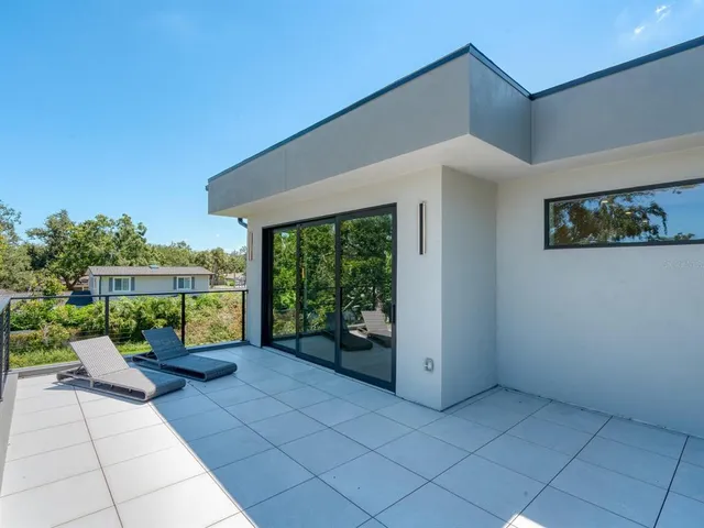 a view of a backyard with a tree