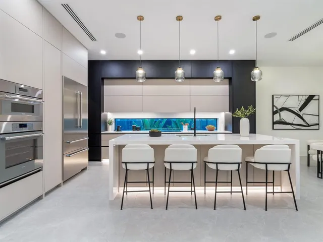 a large kitchen with granite countertop a large window and a sink