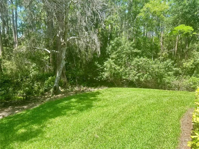 a view of a house with pool and chairs