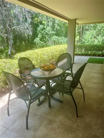 a view of a wooden bench sitting in the middle of a yard