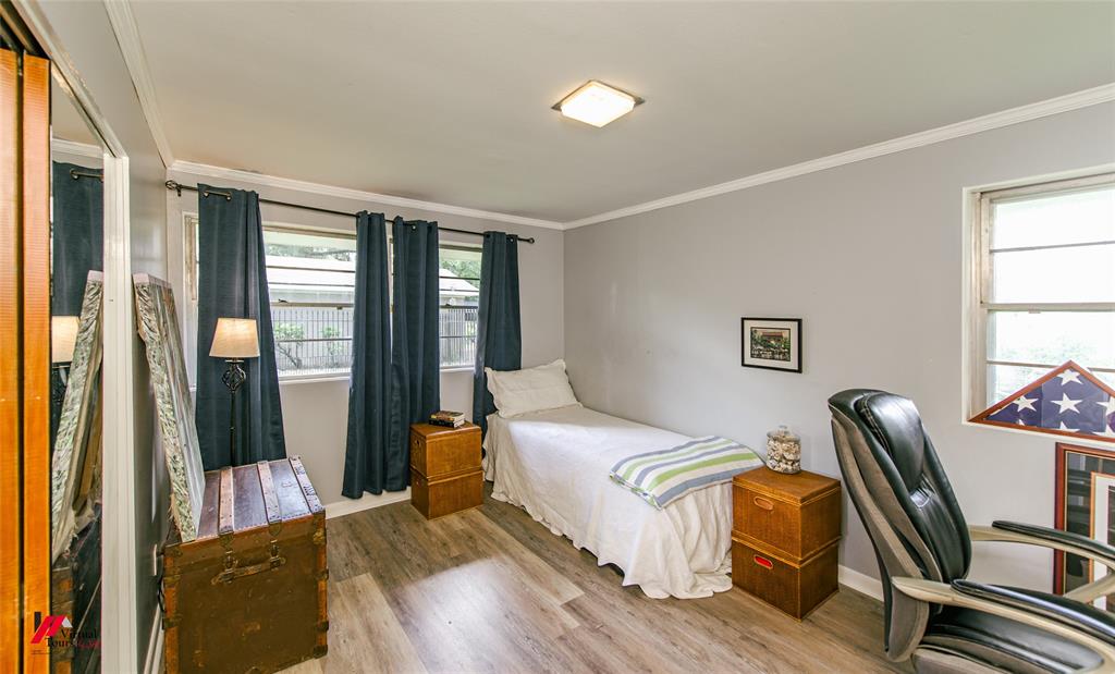 5822 River Road Shreveport, LA 71105 - Photo 16 of 35 a bedroom with a bed wooden floor and a window