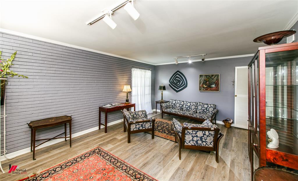 5822 River Road Shreveport, LA 71105 - Photo 2 of 35 a bedroom with furniture and a wooden floor