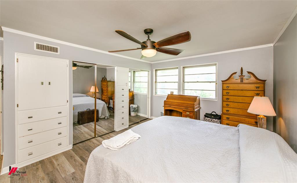 5822 River Road Shreveport, LA 71105 - Photo 22 of 35 a bedroom with a bed and wooden floor