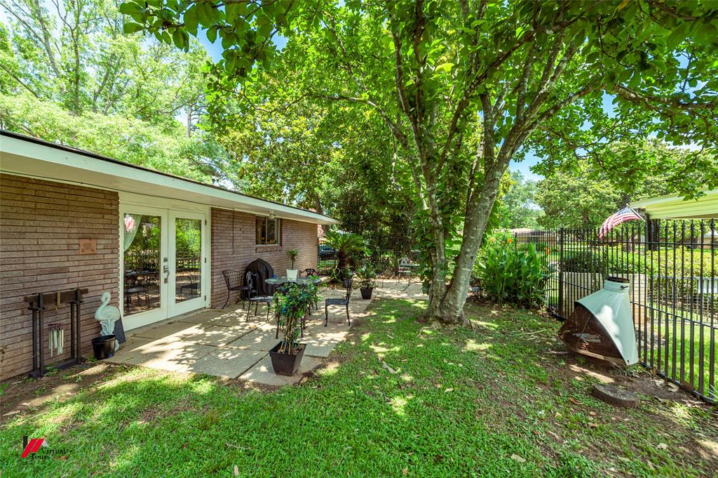 5822 River Road Shreveport, LA 71105 - Photo 26 of 35 a view of a chair and table in backyard of the house