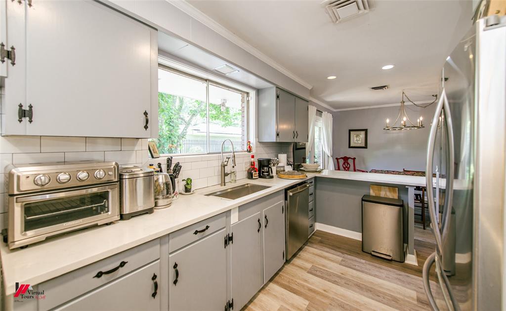 5822 River Road Shreveport, LA 71105 - Photo 9 of 35 a kitchen with a sink stainless steel appliances and cabinets