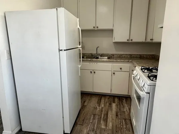a white refrigerator freezer sitting inside of a kitchen
