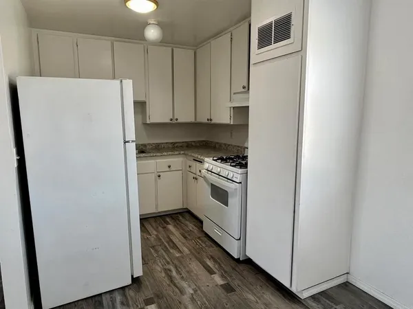 a white refrigerator freezer sitting inside of a kitchen