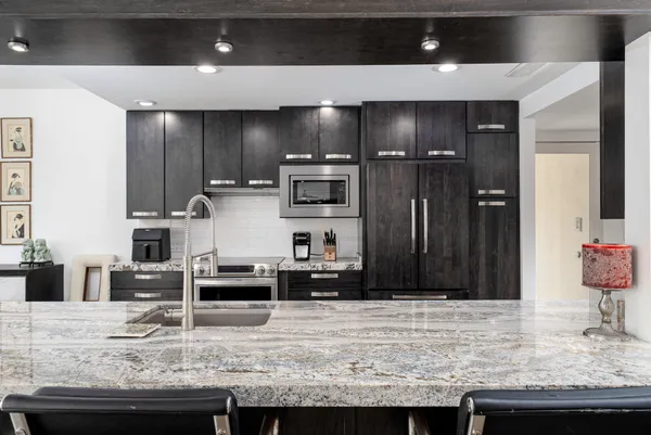 a living room with furniture a flat screen tv and a large window