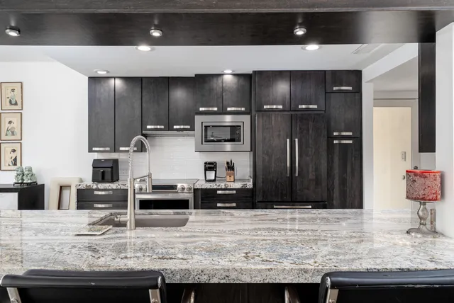 a living room with furniture a flat screen tv and a large window