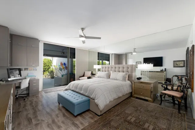 a bedroom with a bed and a television