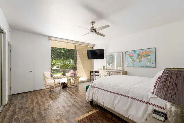 a bathroom with a granite countertop sink a toilet and shower