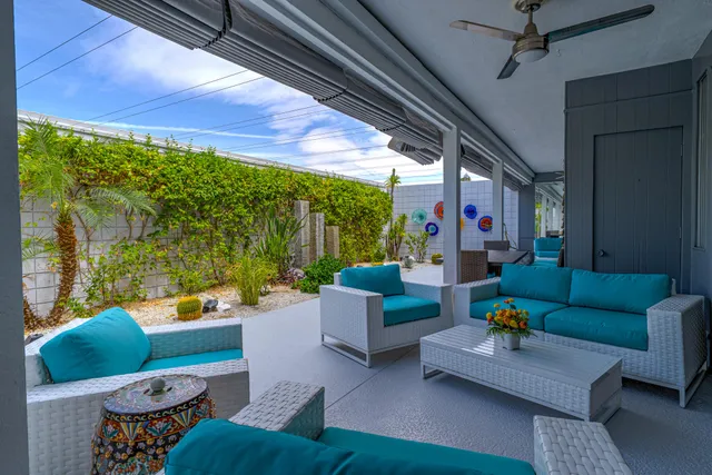 a view of a patio with chairs and potted plants