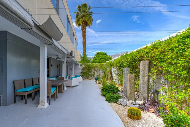 a view of yard from deck with patio