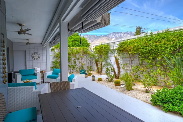 a view of a house with a yard and deck