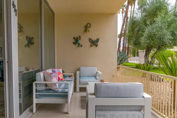 a view of a house with a yard and sitting area