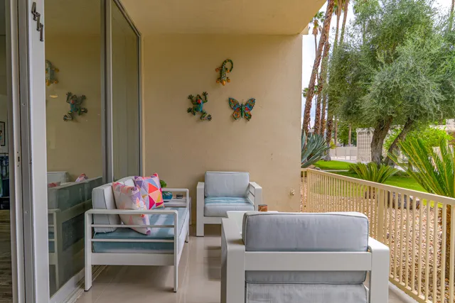 a view of a house with a yard and sitting area