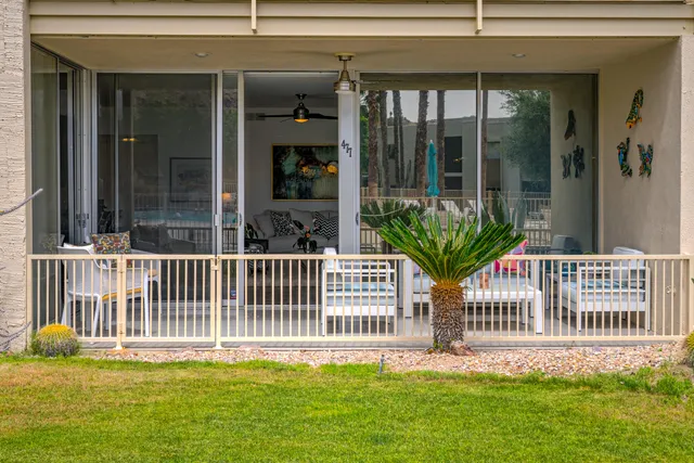 a balcony with furniture and a potted plant