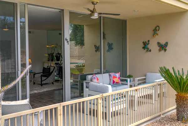 a view of a house with a yard and sitting area