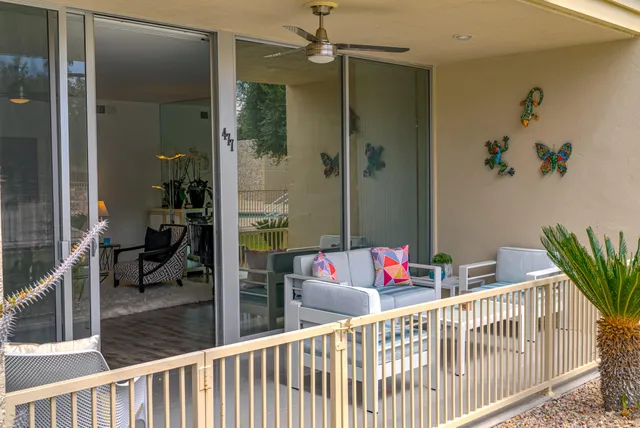 a view of a house with a yard and sitting area