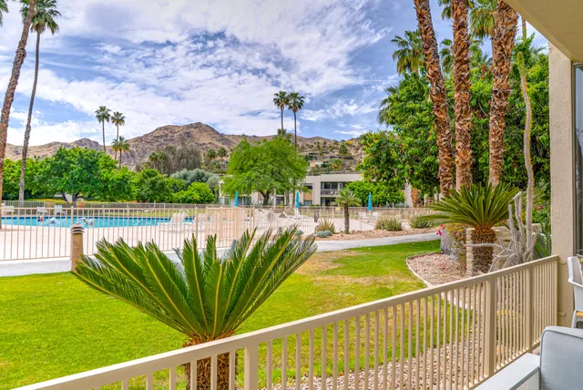 a view of a garden with a table and chairs