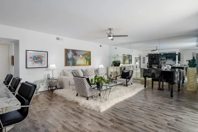 a living room with furniture and wooden floor