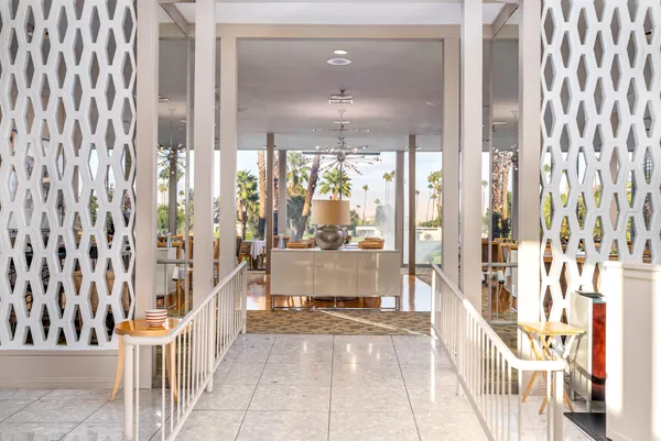 a view of a dining room with furniture large windows and wooden floor