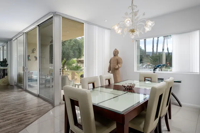 a view of a dining room with furniture and a chandelier