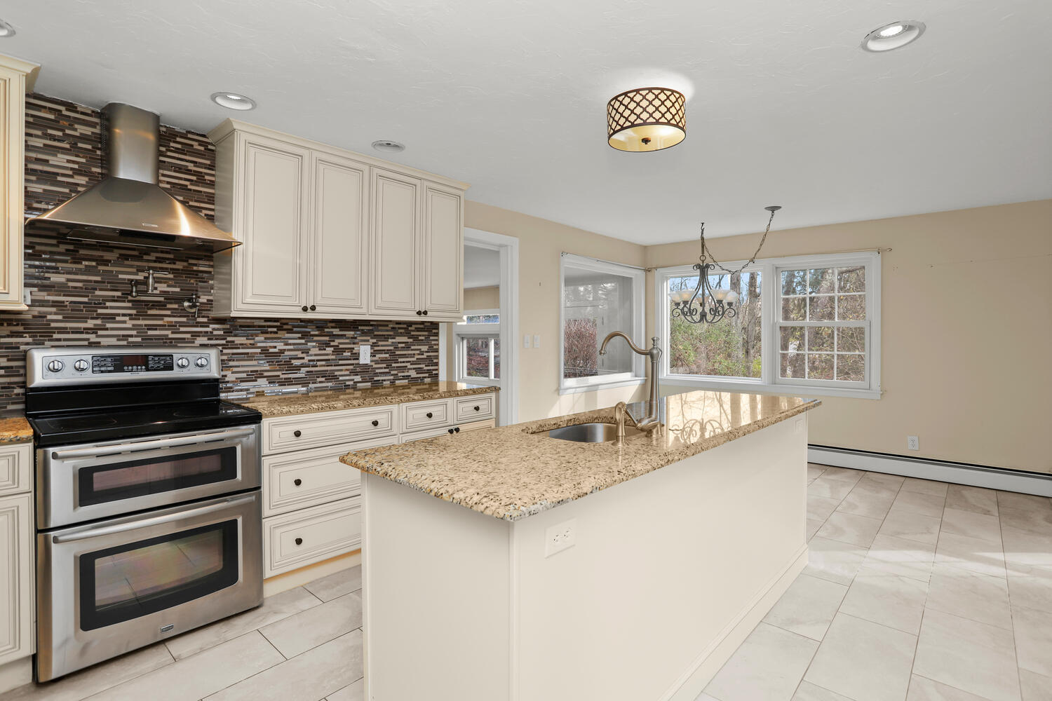 270 Smith Ridge Road New Canaan, CT 06840 - Photo 12 of 36 a kitchen with granite countertop a sink and a stove top oven