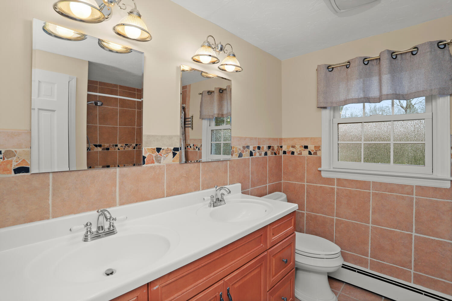 270 Smith Ridge Road New Canaan, CT 06840 - Photo 21 of 36 a bathroom with a sink a toilet and a mirror