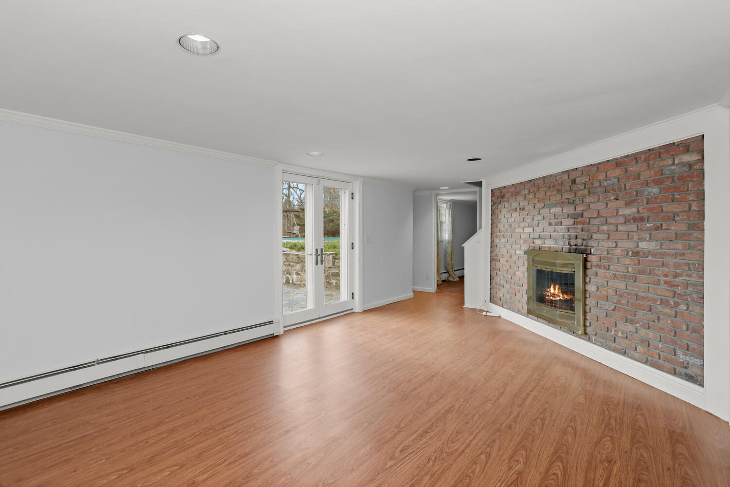 270 Smith Ridge Road New Canaan, CT 06840 - Photo 26 of 36 a view of an empty room with a fireplace and a window