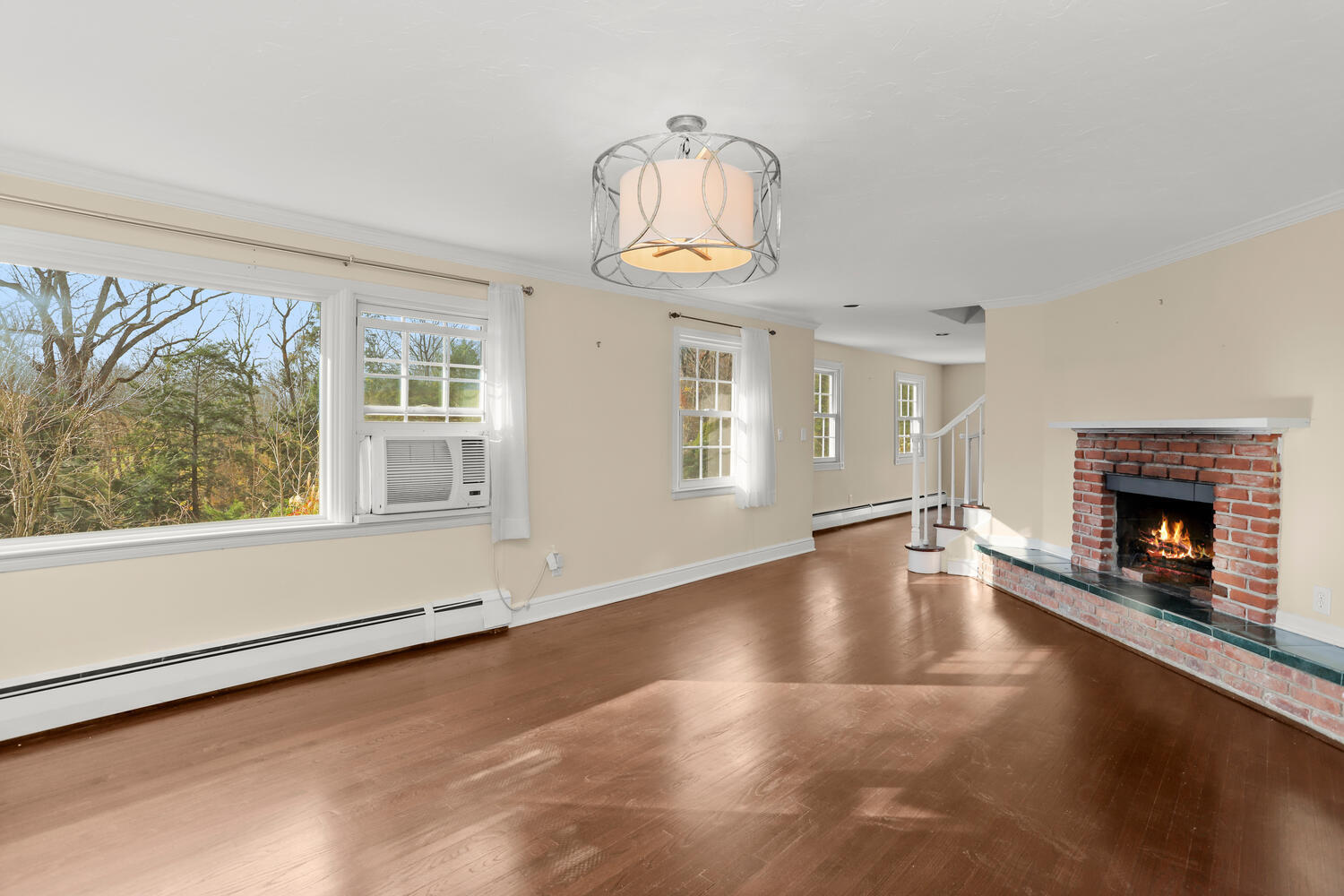 270 Smith Ridge Road New Canaan, CT 06840 - Photo 9 of 36 an empty room with windows and fireplace