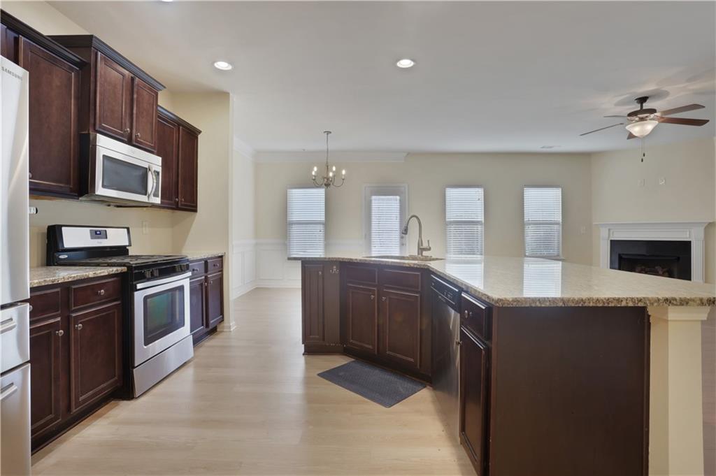 2526 Morgan Chase Drive Buford, GA 30519 - Photo 11 of 44 a large kitchen with stainless steel appliances granite countertop a stove a sink and a microwave