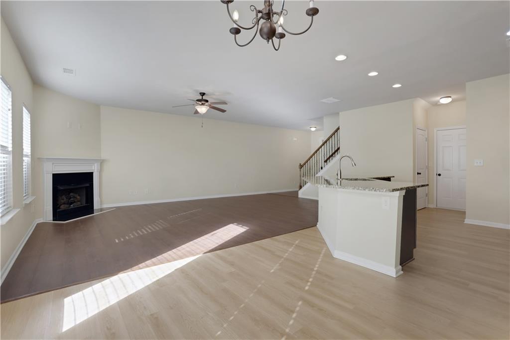 2526 Morgan Chase Drive Buford, GA 30519 - Photo 16 of 44 a view of an empty room with wooden floor and a fireplace