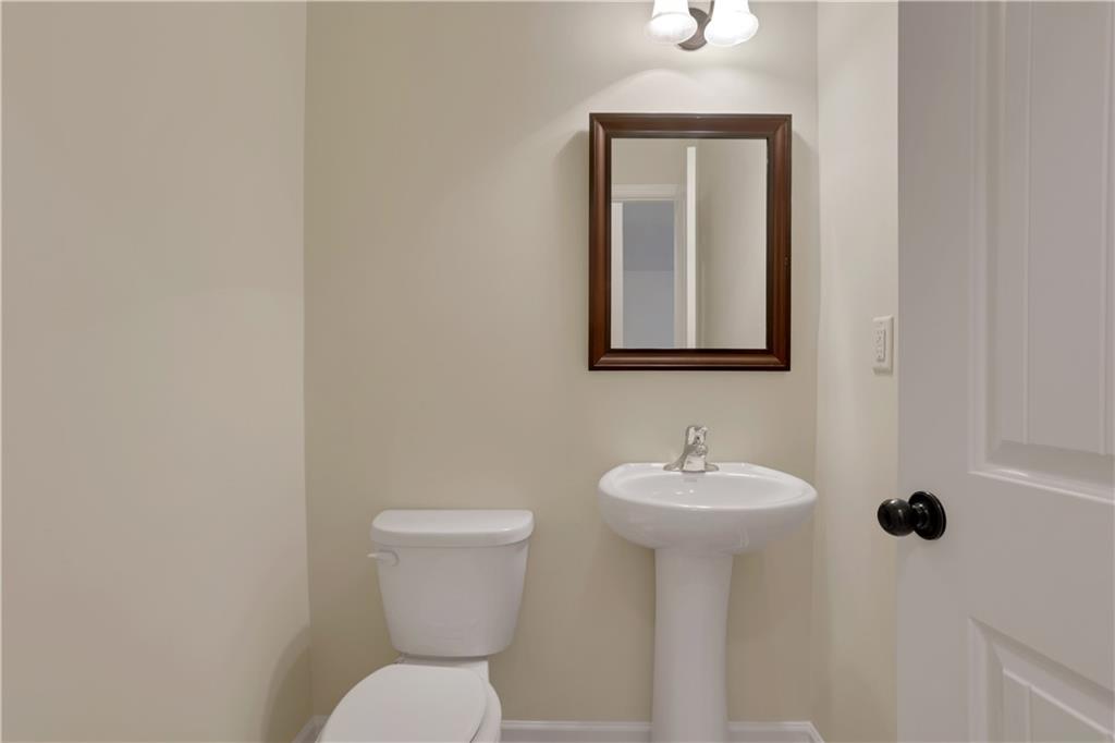 2526 Morgan Chase Drive Buford, GA 30519 - Photo 18 of 44 a bathroom with a toilet sink and mirror