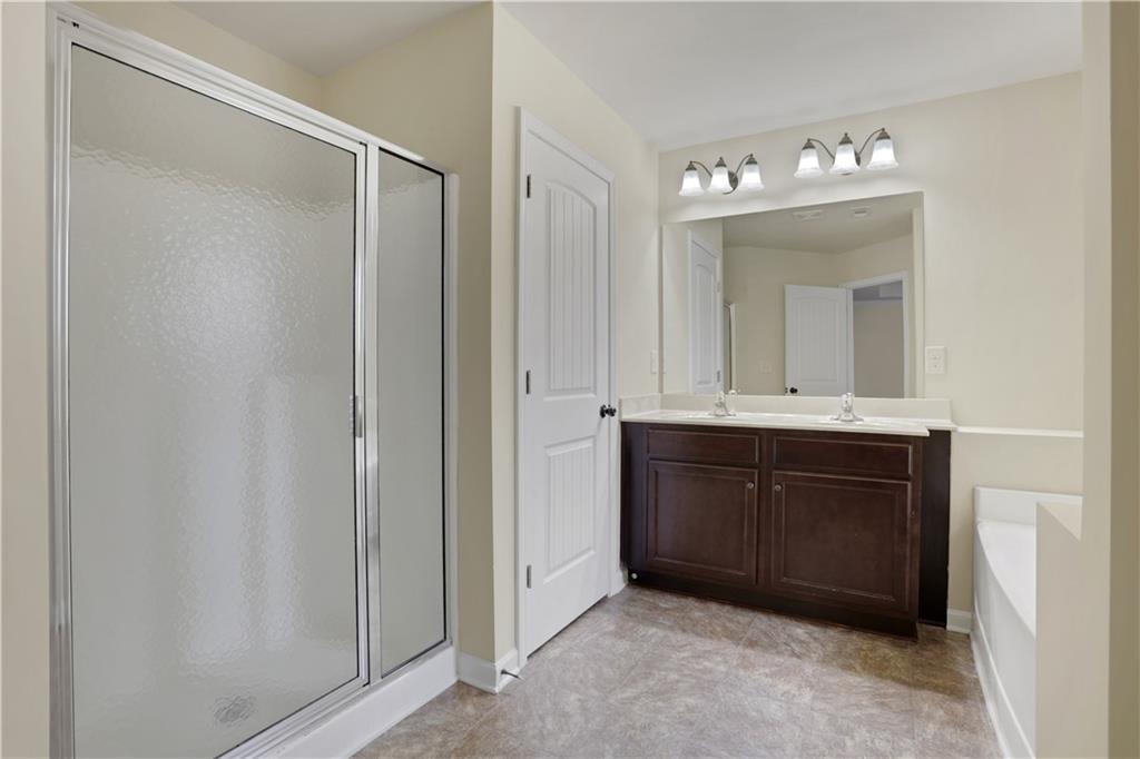 2526 Morgan Chase Drive Buford, GA 30519 - Photo 23 of 44 a bathroom with a sink vanity and mirror