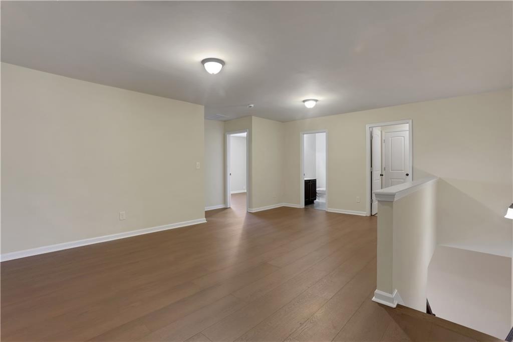 2526 Morgan Chase Drive Buford, GA 30519 - Photo 28 of 44 an empty room with wooden floor and windows