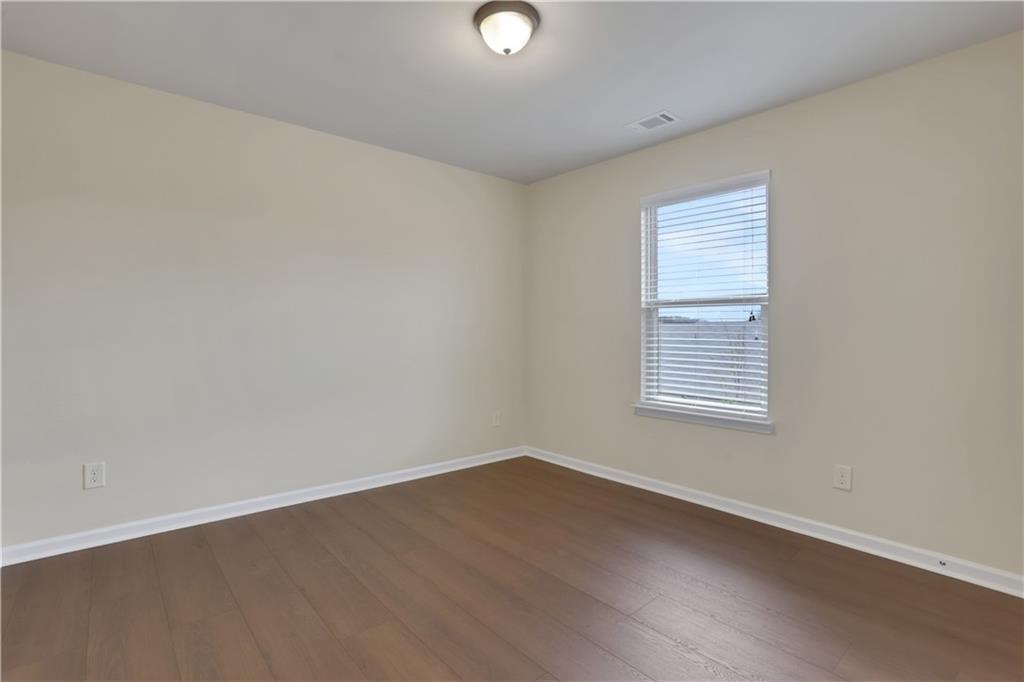 2526 Morgan Chase Drive Buford, GA 30519 - Photo 33 of 44 an empty room with wooden floor and windows