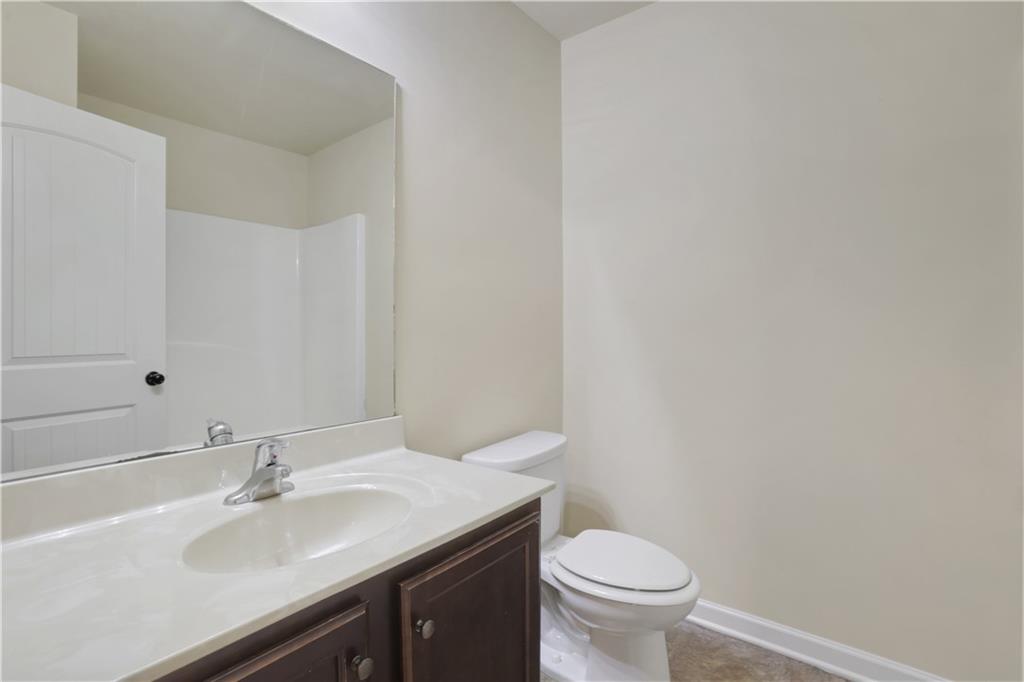 2526 Morgan Chase Drive Buford, GA 30519 - Photo 35 of 44 a bathroom with a sink toilet and a mirror