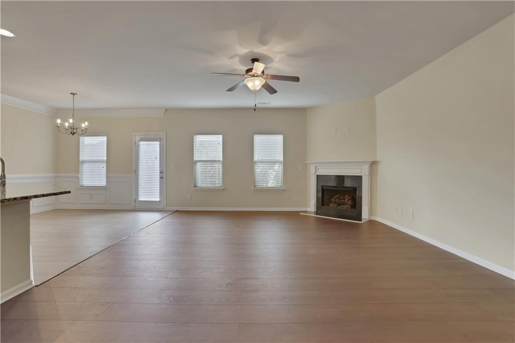 2526 Morgan Chase Drive Buford, GA 30519 - Photo 4 of 44 an empty room with wooden floor fireplace and windows