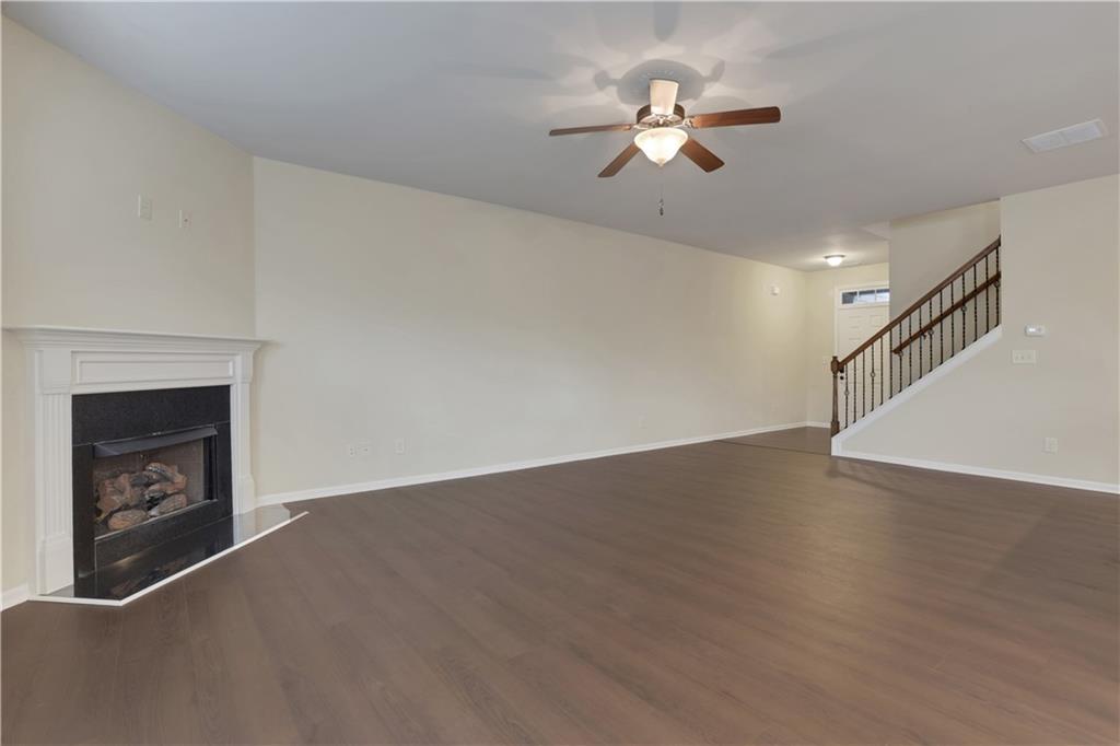 2526 Morgan Chase Drive Buford, GA 30519 - Photo 6 of 44 a view of an empty room with chandelier fan and a fireplace