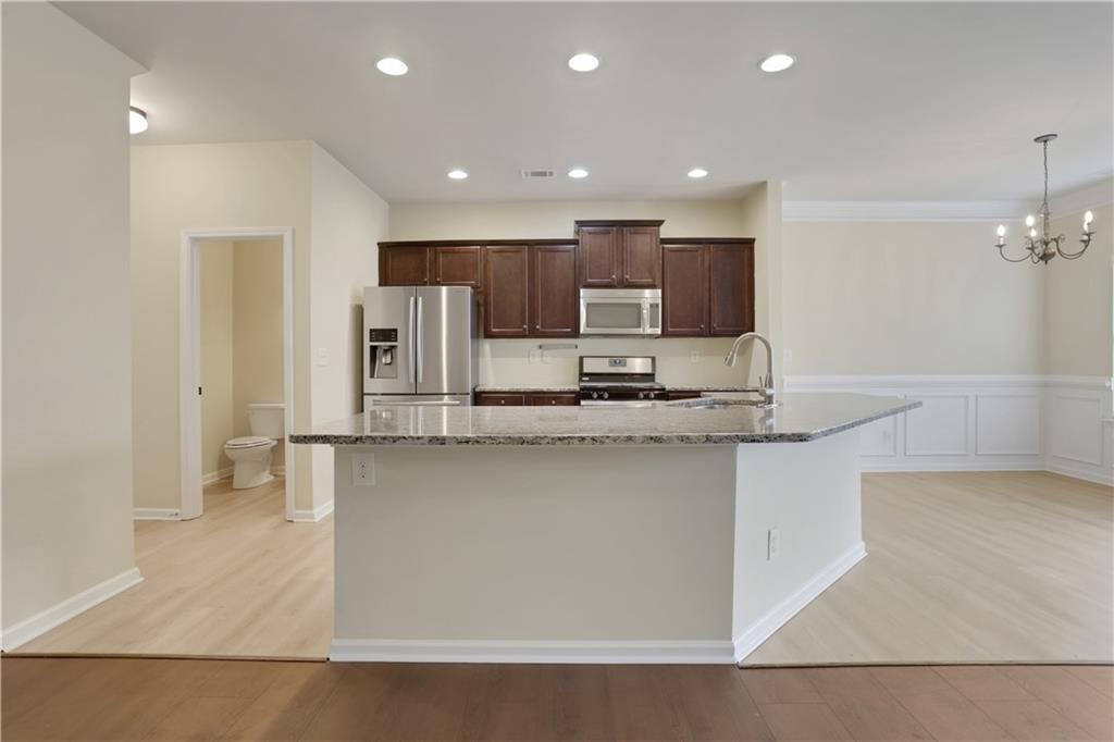 2526 Morgan Chase Drive Buford, GA 30519 - Photo 9 of 44 a kitchen with stainless steel appliances a sink stove and refrigerator