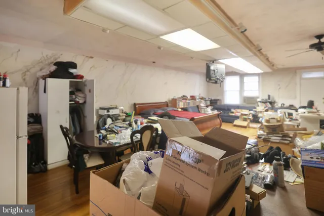 a kitchen with a dining table chairs sink and white cabinets