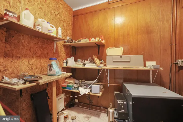 a work room with furniture and a book shelf