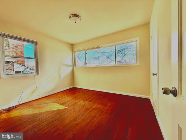 a view of a room with wooden floor and cabinet